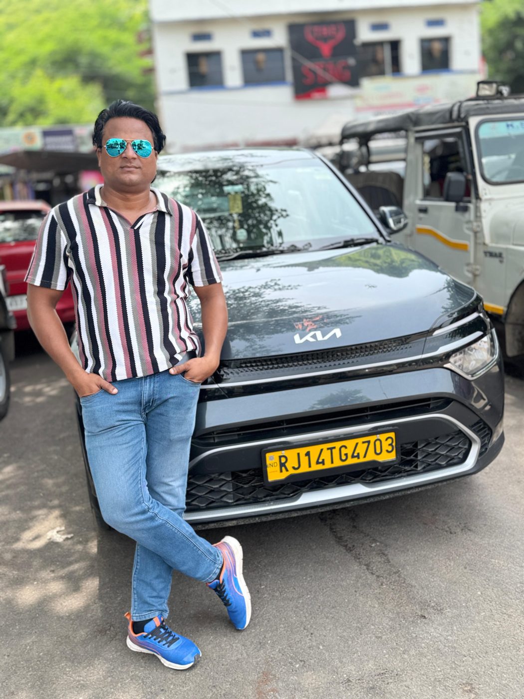 Lokesh (Lucky) Meena with his car in Jaipur